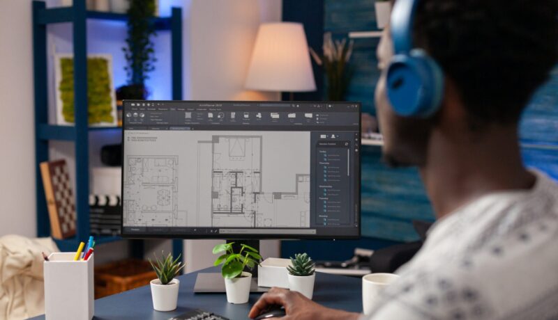 African american architect worker sitting at desk in living room